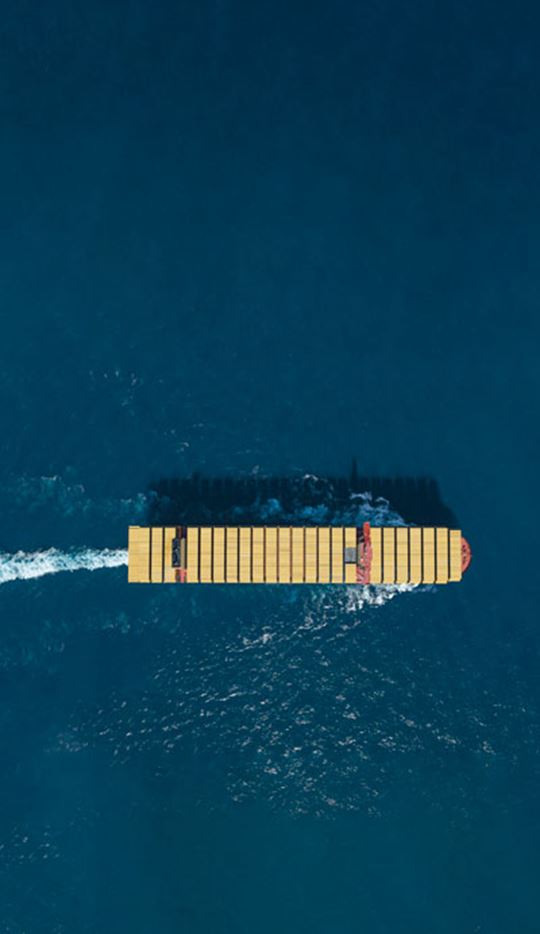 MSC Container Vessel view from the top carrying MSC yellow containers while sailing in deep blue sea