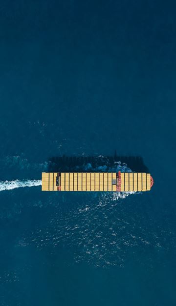 MSC Container Vessel view from the top carrying MSC yellow containers while sailing in deep blue sea